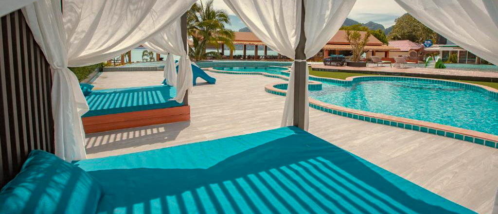Tropical resort with shaded canopy beds and a large swimming pool on the beautiful Phi Phi Islands.