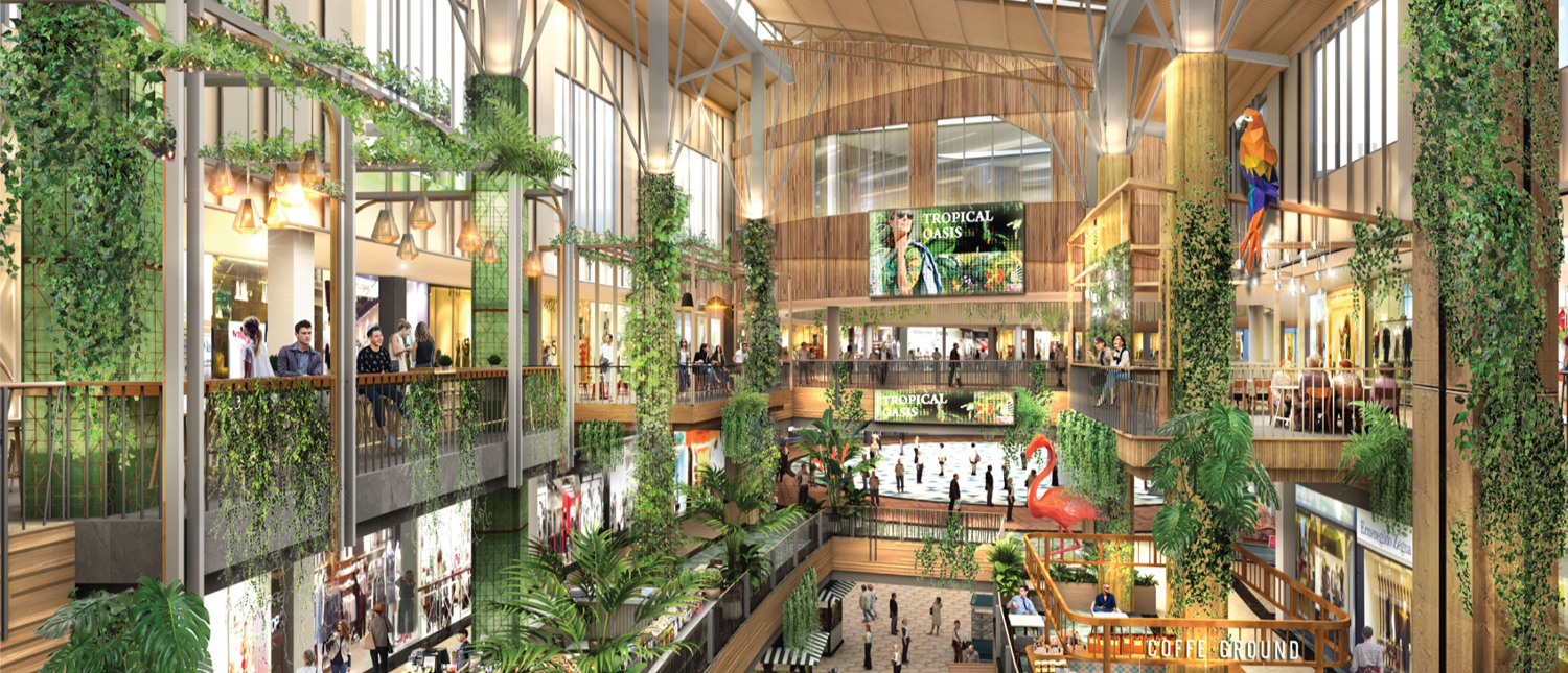 Shoppers explore a modern, multi-level mall in Phuket, adorned with lush green plants and unique decor.