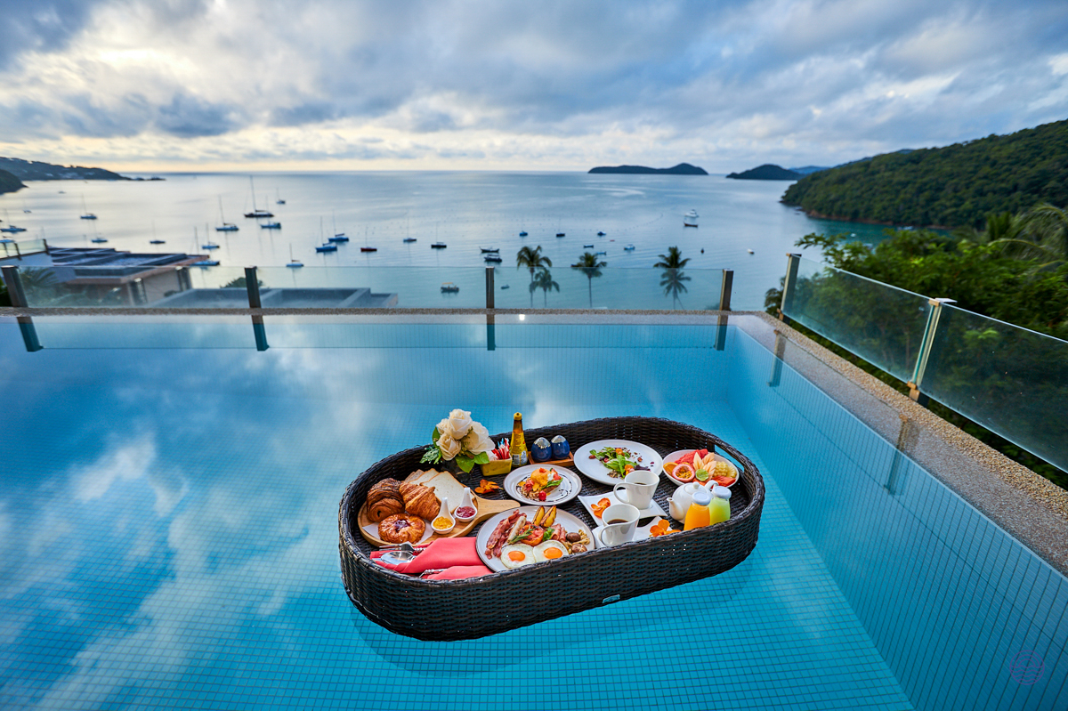 Luxurious floating breakfast in a private infinity pool with stunning views of Phuket's beautiful bay.