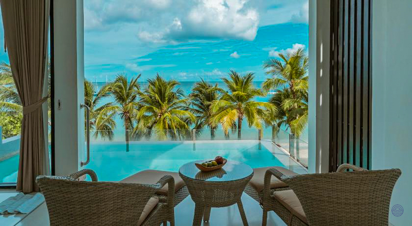 Stunning ocean views from a luxurious Phuket villa, featuring a private pool and tropical palm trees.