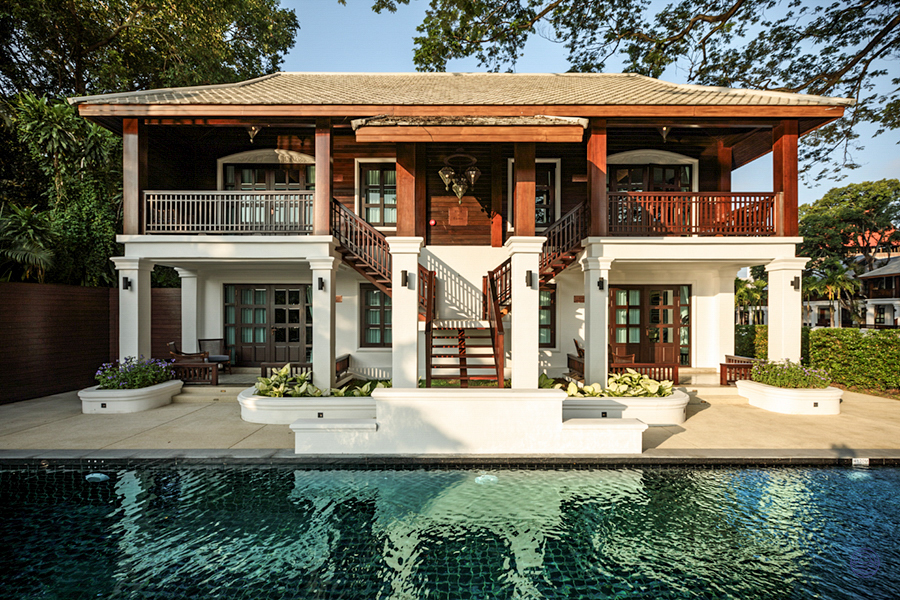 Stunning historical resort building in Chiang Mai, featuring traditional architecture and a serene swimming pool.