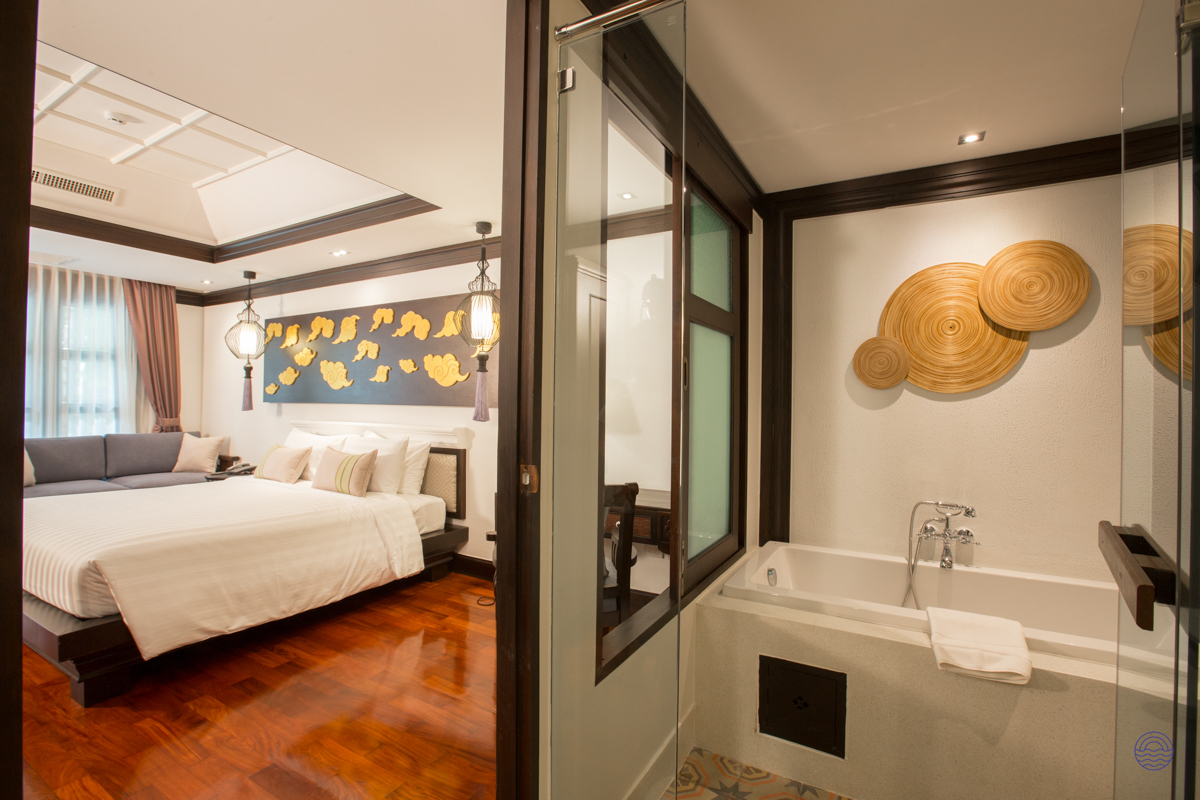 Serene and stylish hotel room in Chiang Mai, offering a comfortable bed and a luxurious soaking tub.
