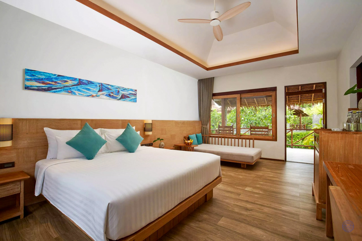 A bright and spacious resort room in Koh Phi Phi with a comfortable bed and tropical garden view.