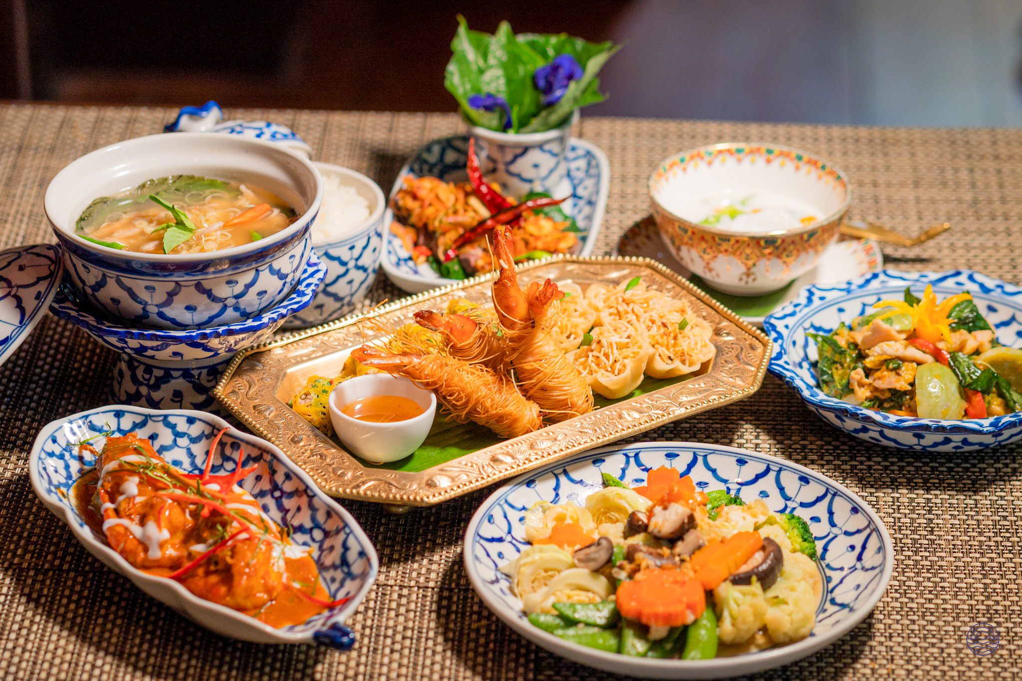 An inviting array of authentic Thai dishes, including fried prawns and stir-fry, served in Bangkok.