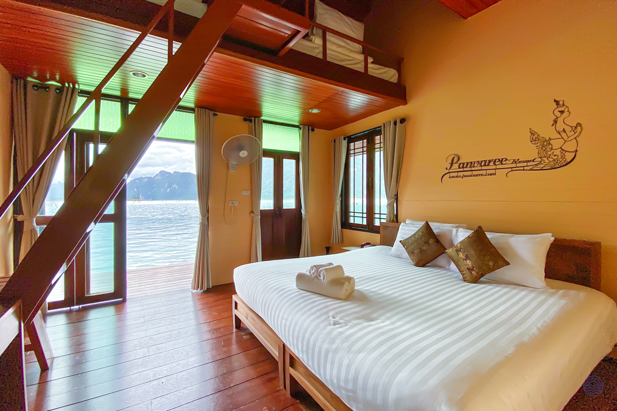 Spacious bedroom at Panvaree Resort in Khao Sok, with a large bed and scenic lake views.