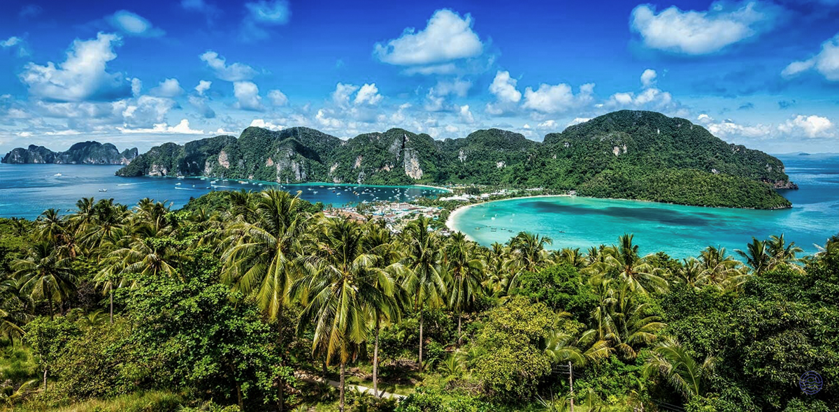 Breathtaking aerial view of Koh Phi Phi's twin bays, surrounded by lush jungle and limestone karsts.