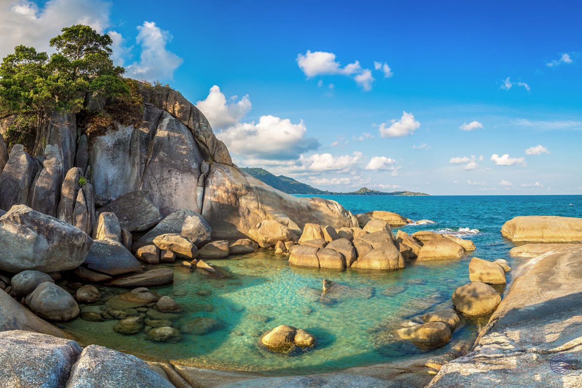 Clear turquoise waters gently lap against the unique Hin Ta and Hin Yai rock formations on Koh Samui.