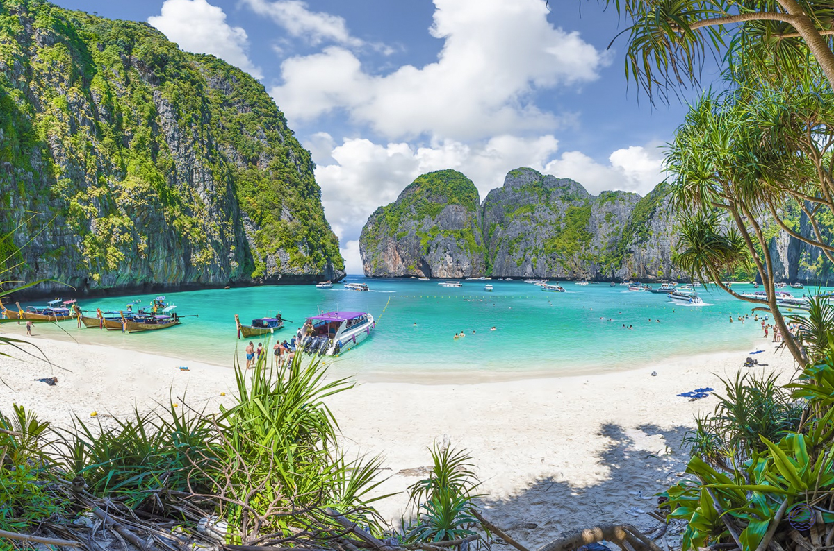 A stunning view of Maya Bay in Krabi, Thailand, with turquoise water and dramatic limestone cliffs.