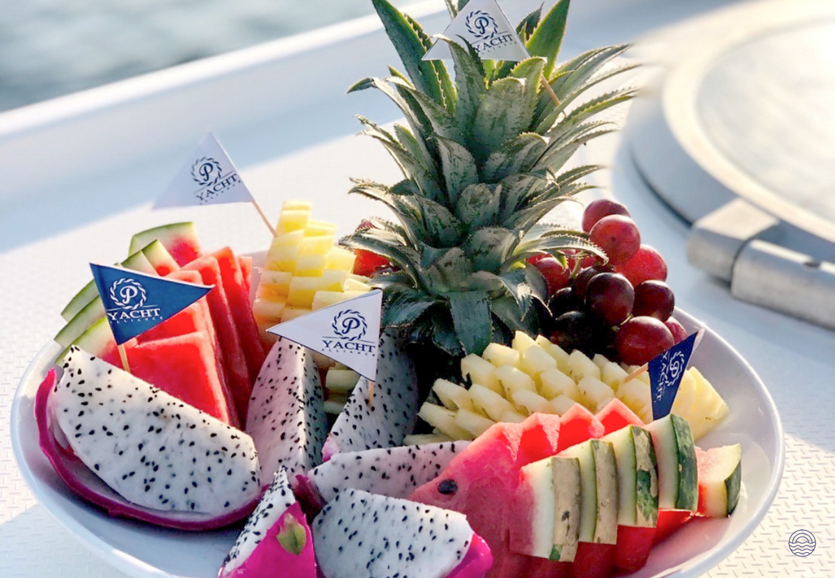 A vibrant platter of fresh tropical fruit served on a yacht during a sunset cruise in Phuket.