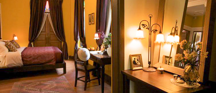 Inviting hotel room in Bangkok featuring a comfortable bed, desk, and elegant decor.