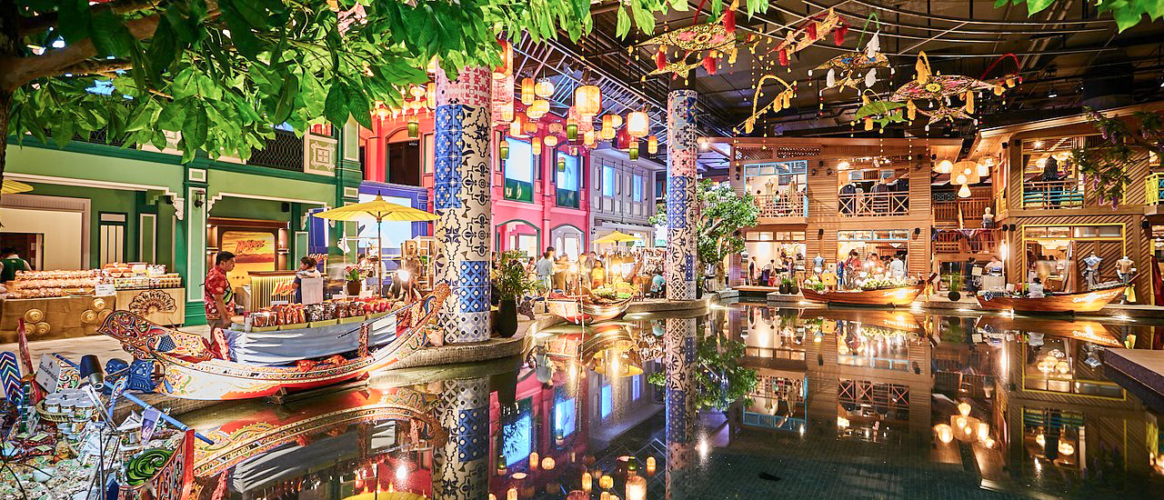 A vibrant indoor floating market in Bangkok with colorful shops, traditional boats, and lanterns.