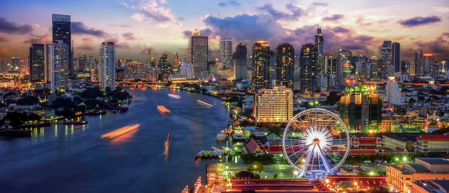 Vibrant Bangkok cityscape at dusk with illuminated skyscrapers, river boats, and a glowing Ferris wheel.