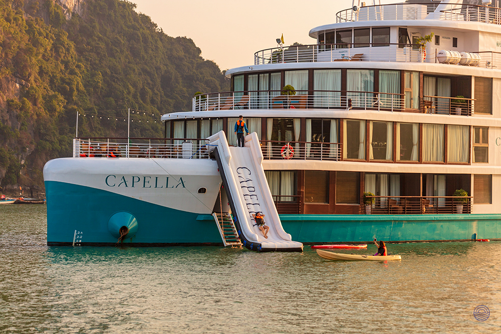 Enjoy a thrilling water slide and kayaking from the Capella cruise ship in beautiful Halong Bay.