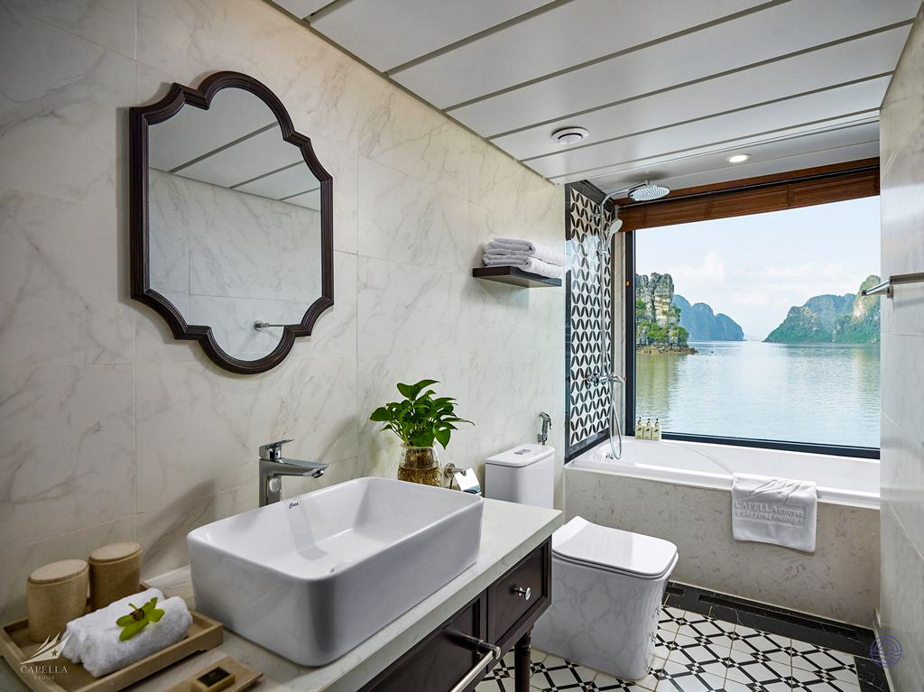 Luxurious cruise bathroom with an ocean-view bathtub offering stunning vistas of Halong Bay.