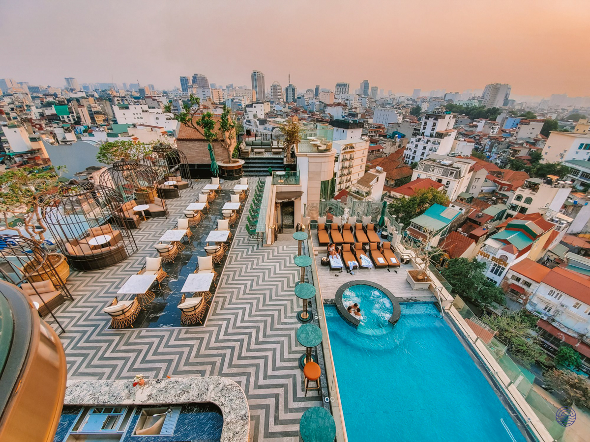 Luxurious rooftop pool and bar with stunning city views at the Peridot Grand Hotel in Hanoi.