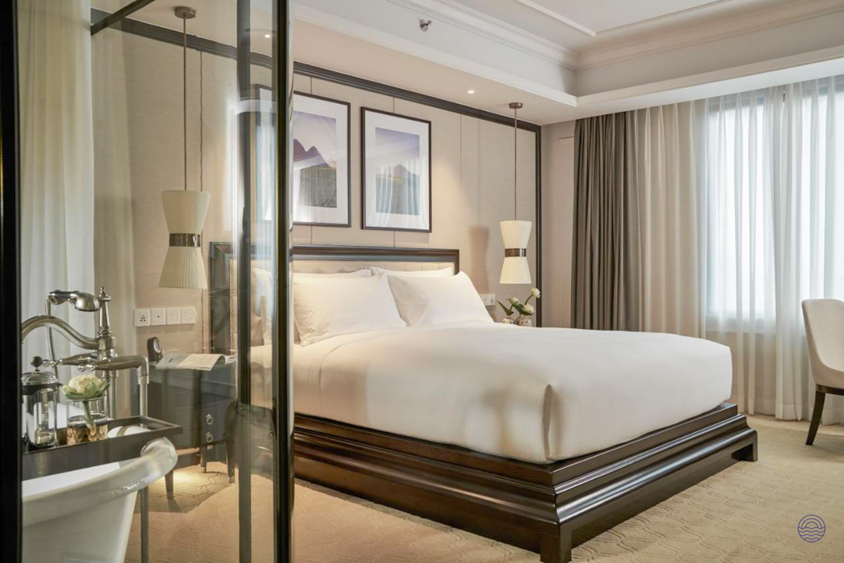 A luxurious hotel bedroom with a large bed and elegant decor, perfect for unwinding in Ho Chi Minh City.