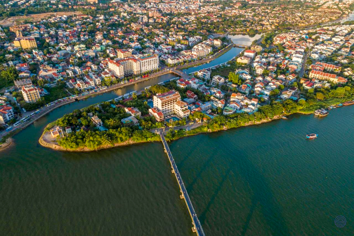 Hoi An's beautiful riverfront city with bridges connecting islands and a mix of buildings.