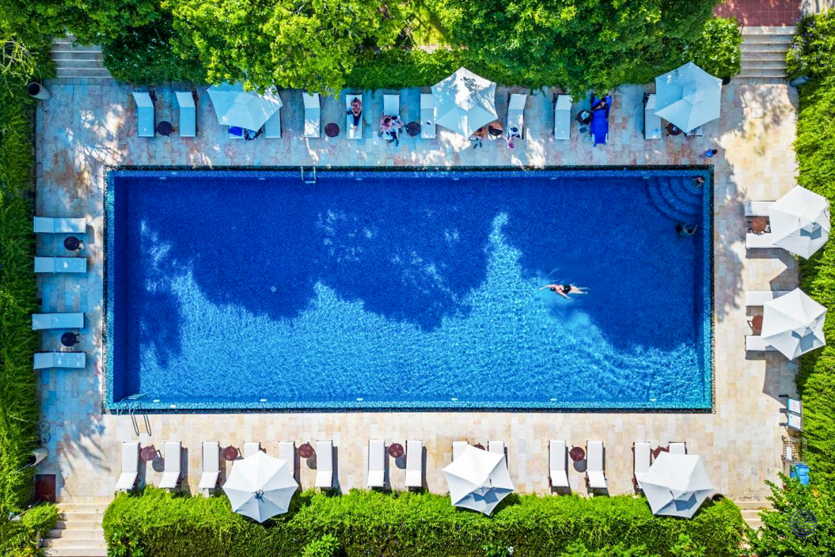 Relax and swim in the inviting blue pool at your comfortable accommodation in Hoi An.