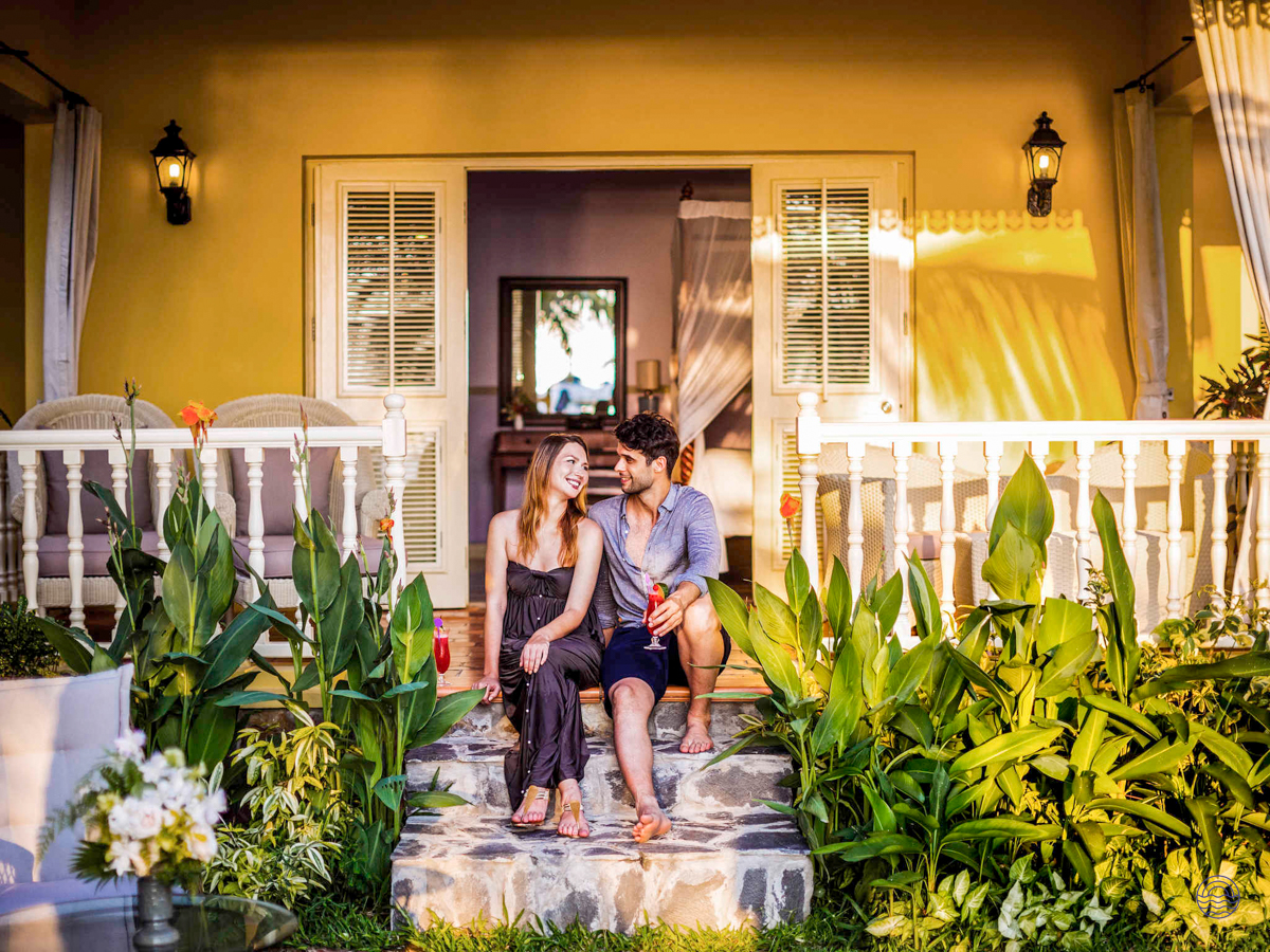 A couple enjoys a romantic moment on the steps of their beautiful Phu Quoc resort.