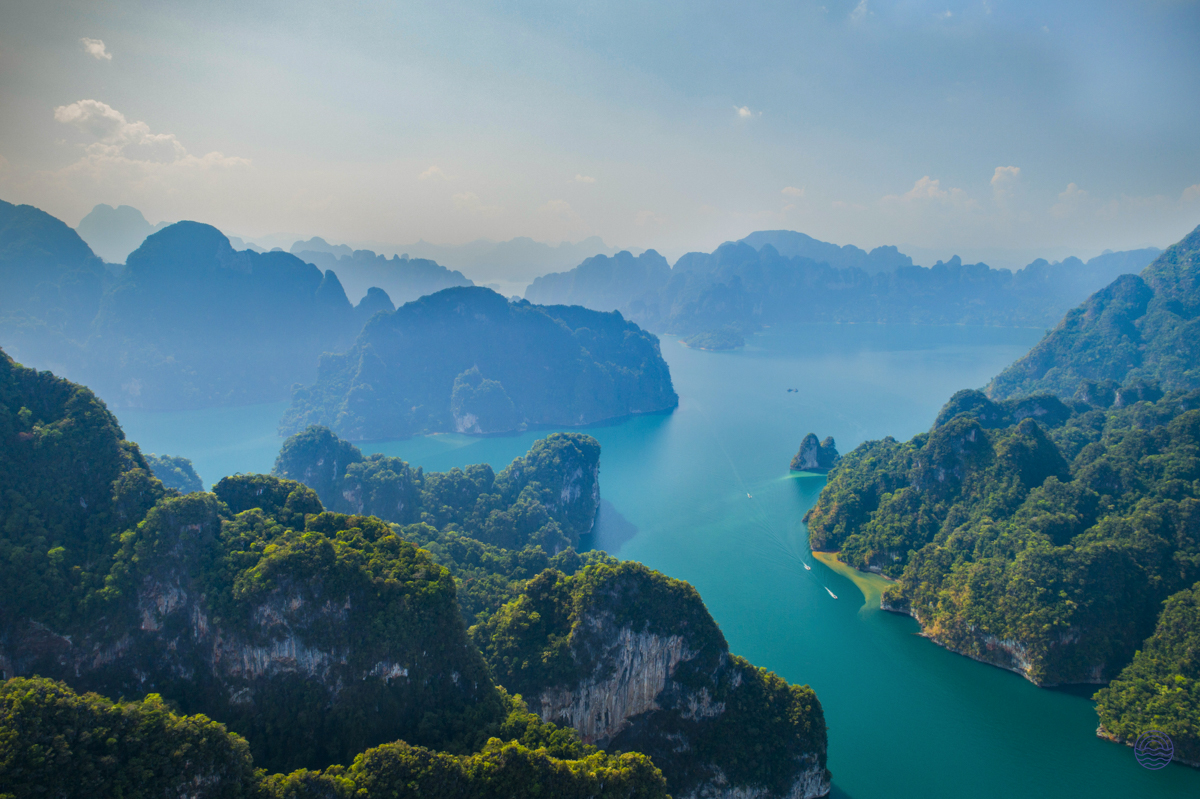 Stunning aerial view of Halong Bay's emerald waters and majestic limestone karsts covered in green foliage.