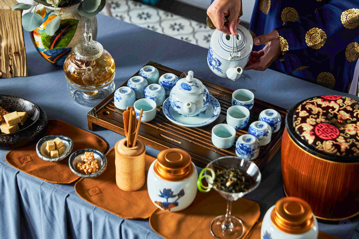 Enjoying a serene Vietnamese tea ceremony with traditional blue and white porcelain in Halong Bay.