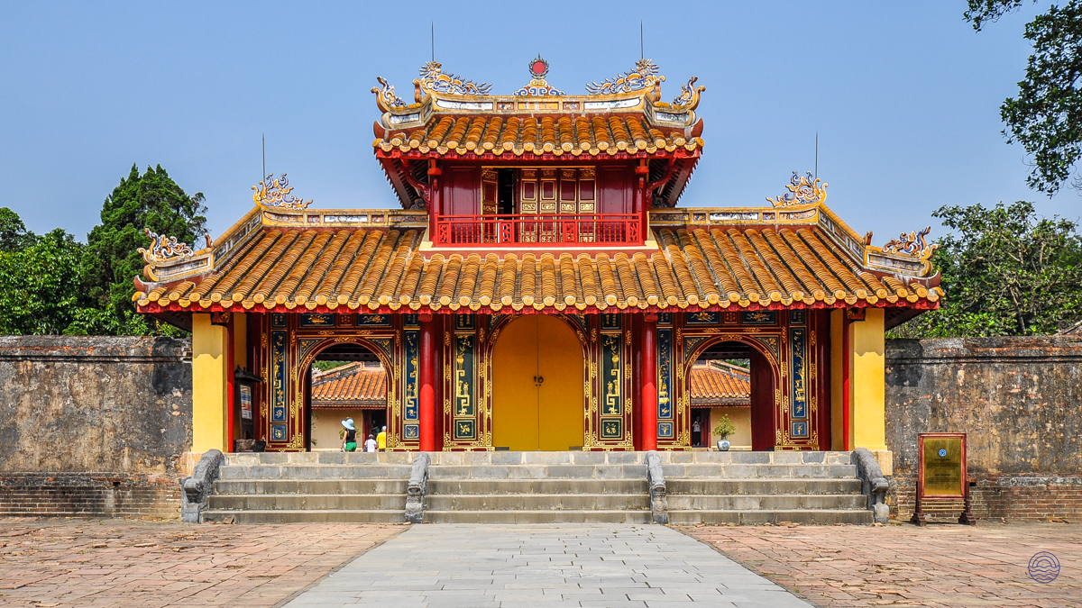 The grand, ornate entrance to Hue's Imperial Citadel, featuring traditional yellow and red architecture.