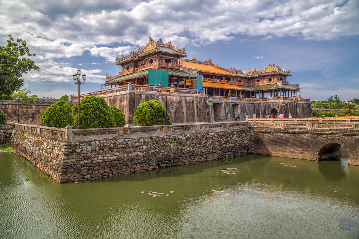 The majestic Imperial Citadel in Hue, Vietnam, stands grandly beside its reflective moat.