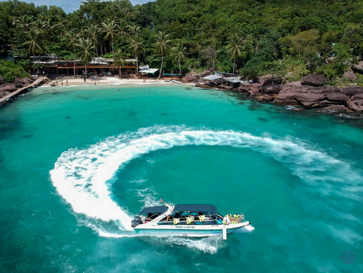 An exciting speed boat ride in the clear turquoise waters of Phu Quoc, near a tropical beach.