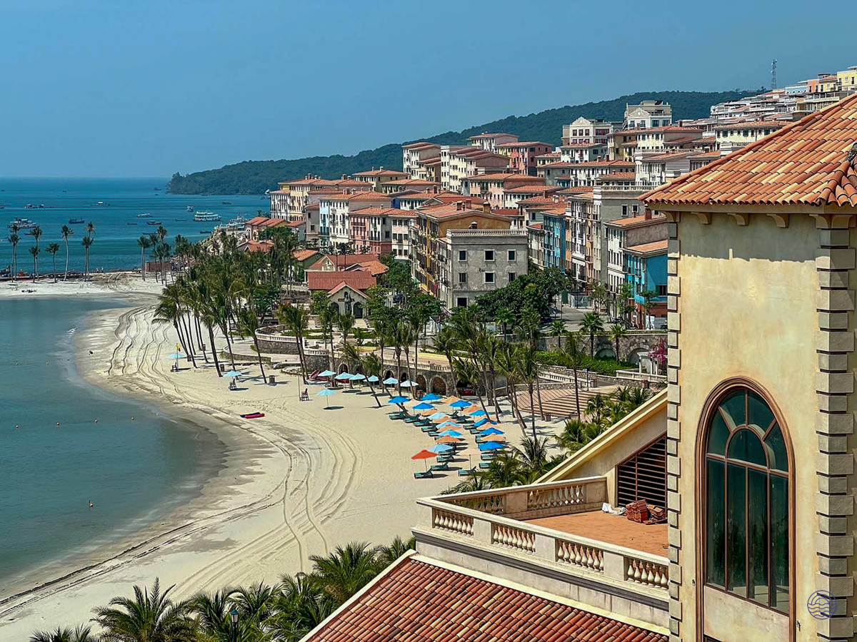 Stunning resort town on Phu Quoc island, featuring a sandy beach, palm trees, and charming coastal architecture.