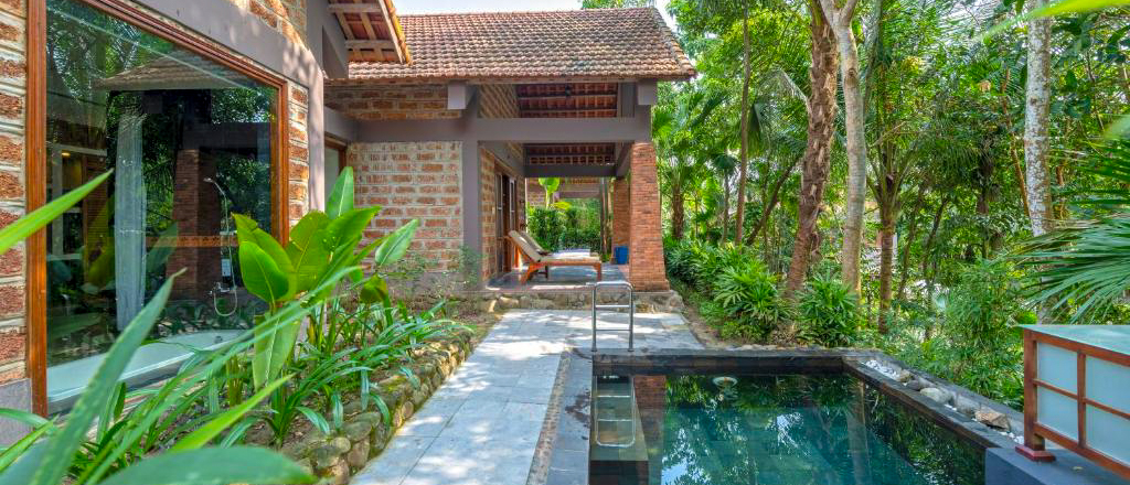 A tranquil private pool hut with lush tropical gardens and a plunge pool in Hue, Vietnam.