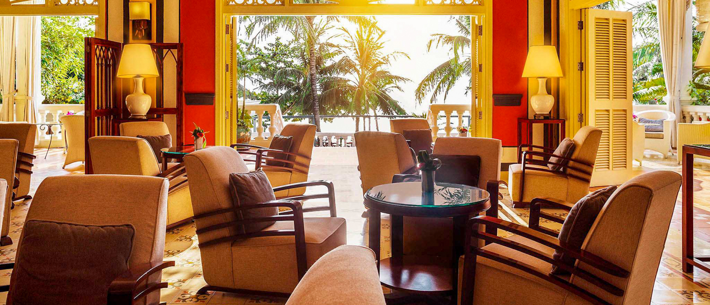 Elegant resort lounge in Phu Quoc, offering a relaxing view of palm trees and the ocean.