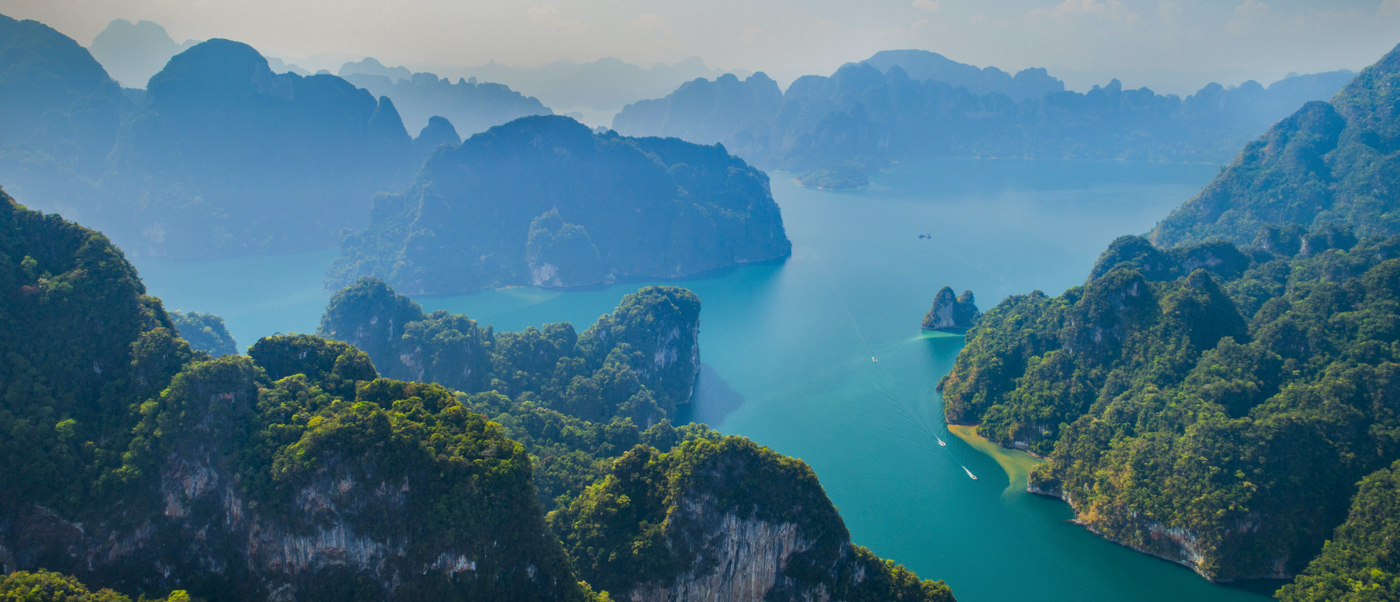 Stunning aerial view of Halong Bay's iconic limestone karsts and calm emerald waters.