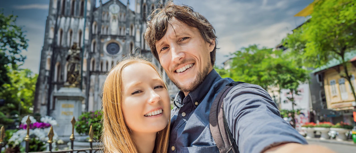 A happy couple takes a selfie in front of St. Joseph's Cathedral in Hanoi.